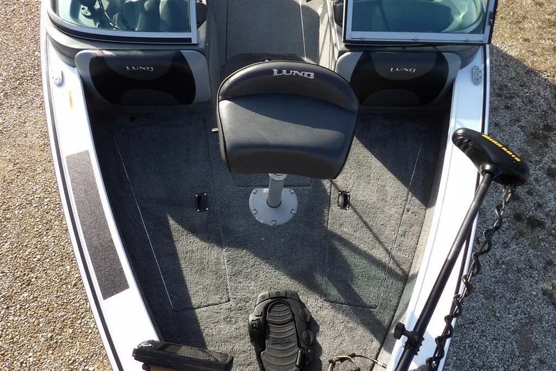 Slide: The Image of 2025 Lund 1875 Crossover XS boat interior with seating and controls. - 35