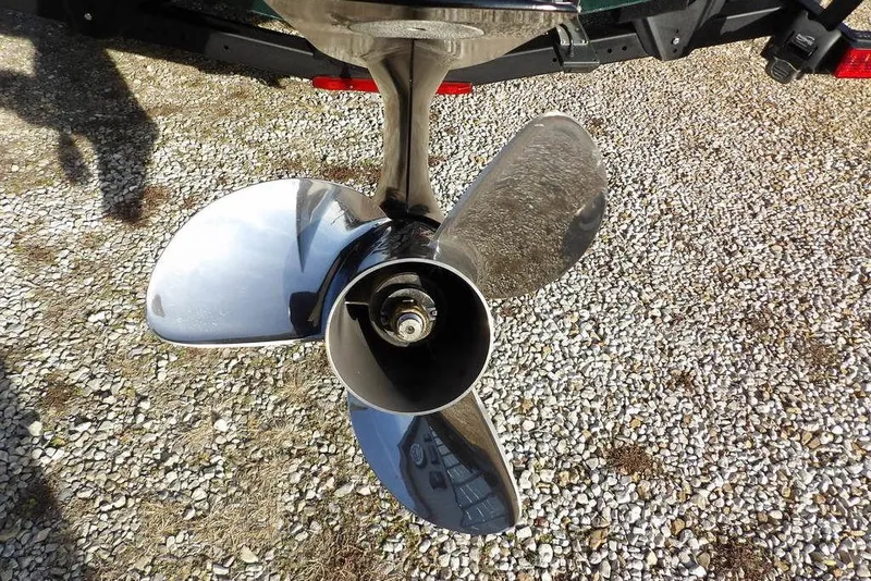 Slide: The Image of 2025 Lund 1875 Crossover XS boat propeller on gravel surface. - 45