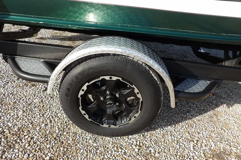 Slide: The Image of Trailer wheel of 2025 Lund 1875 Crossover XS on gravel surface. - 49
