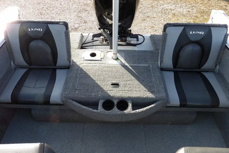 Slide: The Image of 2025 Lund 1875 Crossover XS boat interior with gray seating and cup holders. - 9