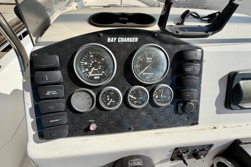 Slide: The Image of Dashboard of 2004 PlayCraft 22 Bay Charger boat with gauges and controls. - 11