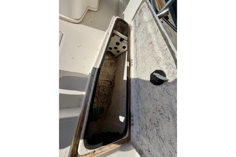 Slide: The Image of Open storage compartment on 2004 PlayCraft 22 Bay Charger boat, showing interior details. - 18