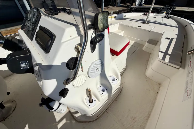 Slide: The Image of 2004 PlayCraft 22 Bay Charger boat interior with control panel and seating. - 20