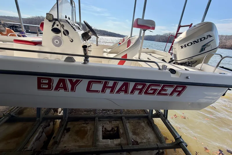 Slide: The Image of 2004 PlayCraft 22 Bay Charger boat with Honda engine docked by the lake. - 24