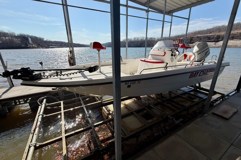 Slide: The Image of 2004 PlayCraft 22 Bay Charger boat docked on a sunny lake. - 25