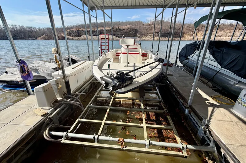 Slide: The Image of 2004 PlayCraft 22 Bay Charger boat docked on a lake with covered slip. - 26