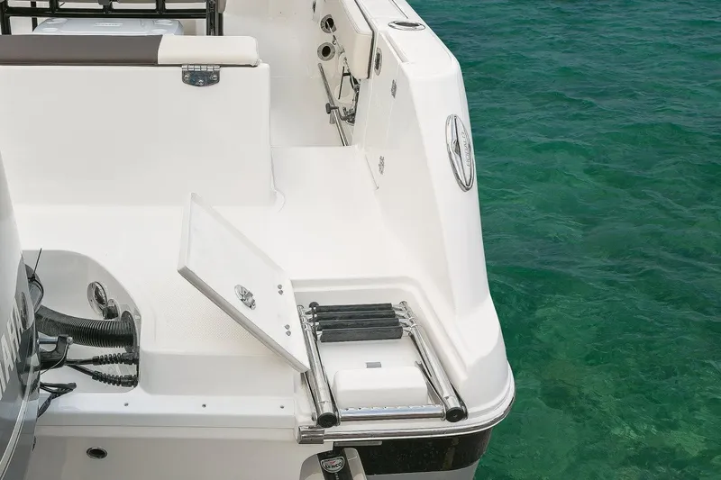 Slide: The Image of Manufacturer Provided Image: 2019 Robalo R242 Explorer boat stern with swim ladder and storage compartment. - 10
