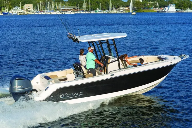 Slide: The Image of Manufacturer Provided Image: 2019 Robalo R242 Explorer boat cruising on a lake with passengers. - 2