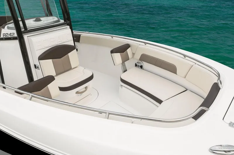Slide: The Image of Manufacturer Provided Image: 2019 Robalo R242 Explorer boat interior with cushioned seating and ocean backdrop. - 4