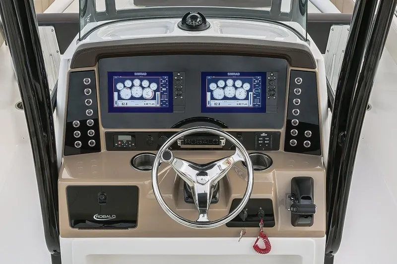 Slide: The Image of Manufacturer Provided Image: 2019 Robalo R242 Explorer boat dashboard with dual Simrad displays and steering wheel. - 6