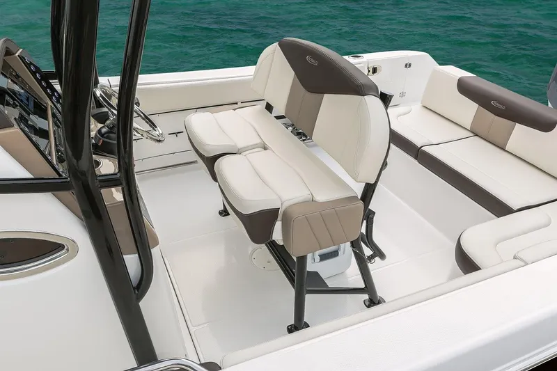 Slide: The Image of Manufacturer Provided Image: 2019 Robalo R242 Explorer boat interior with cushioned seating and steering console. - 7