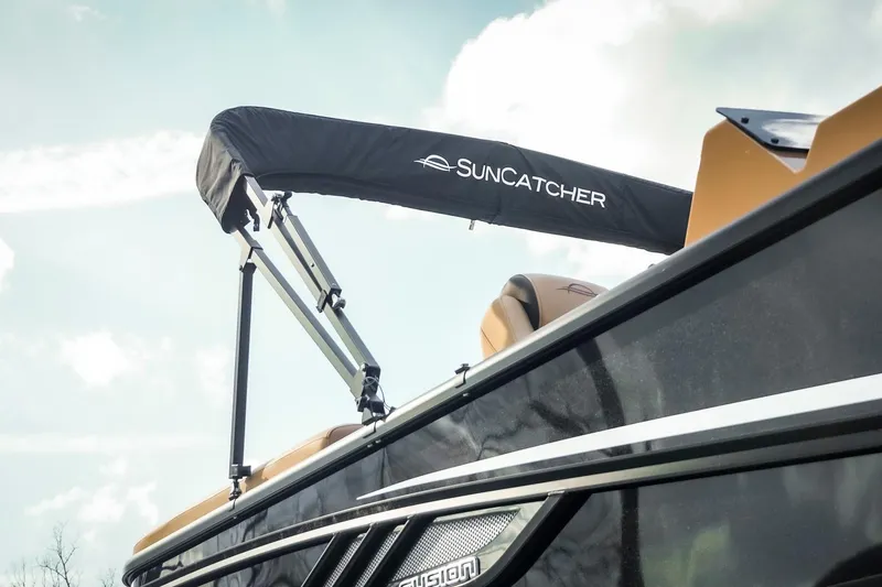 Slide: The Image of 2025 SunCatcher Fusion 324RC boat with canopy against a cloudy sky. - 11