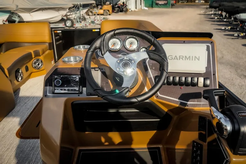 Slide: The Image of 2025 SunCatcher Fusion 324RC boat dashboard with Garmin navigation and modern controls. - 12