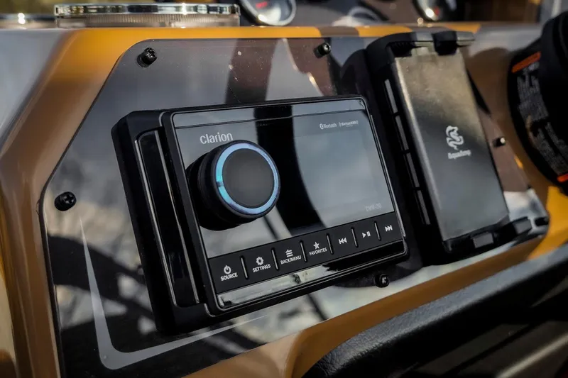 Slide: The Image of Clarion audio system in 2025 SunCatcher Fusion 324RC boat dashboard. - 15