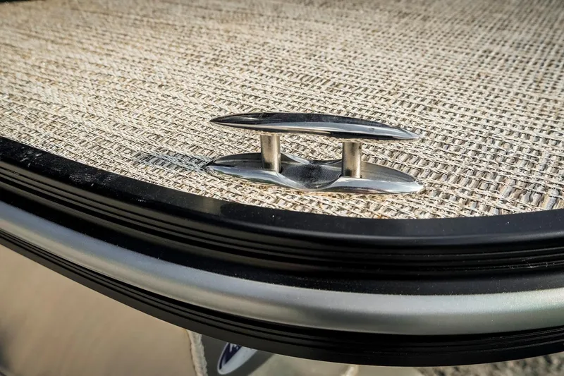 Slide: The Image of 2025 SunCatcher Fusion 324RC boat cleat on textured deck surface. - 20