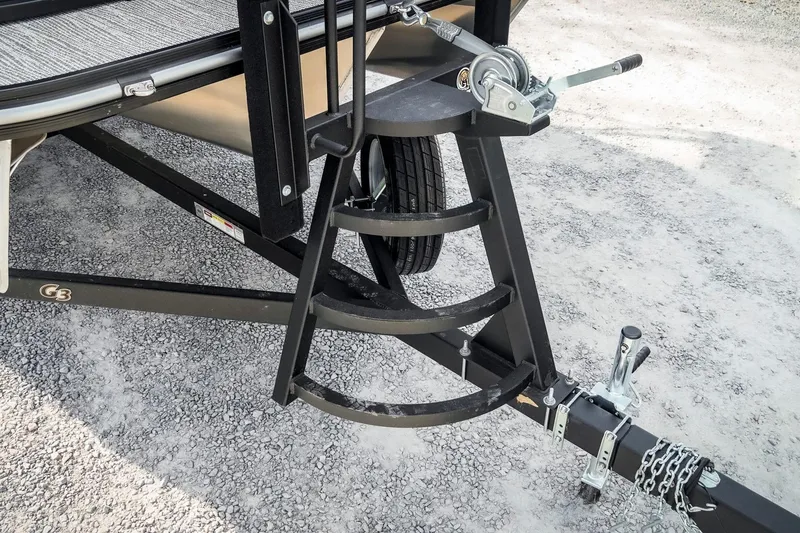 Slide: The Image of Trailer hitch and winch of 2025 SunCatcher Fusion 324RC on gravel surface. - 22