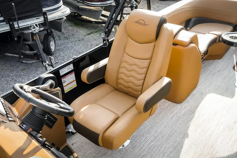 Slide: The Image of Luxurious tan captain's chair in 2025 SunCatcher Fusion 324RC boat interior. - 23