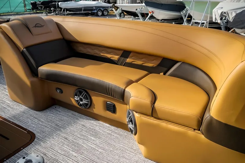 Slide: The Image of Luxurious seating on 2025 SunCatcher Fusion 324RC boat, featuring premium leather and built-in speakers. - 29