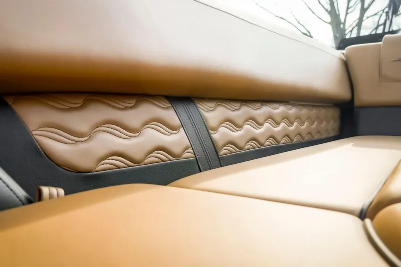 Slide: The Image of Luxurious tan leather interior of 2025 SunCatcher Fusion 324RC with wave pattern design. - 32