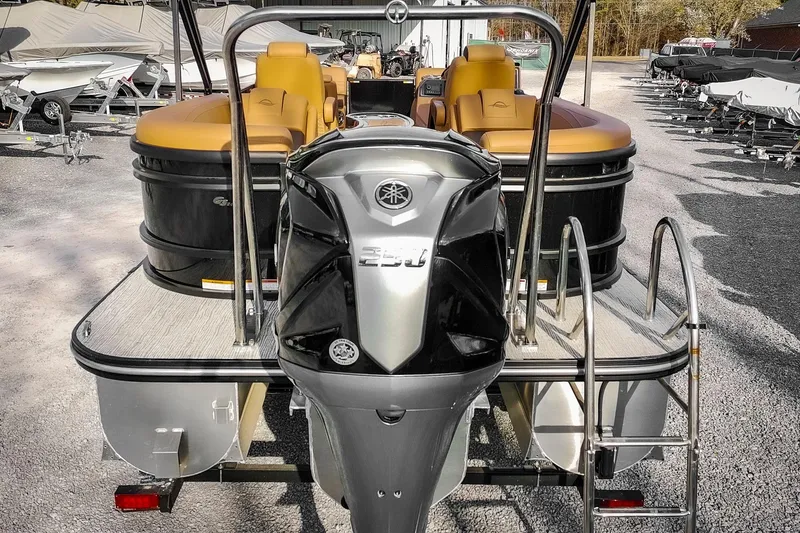 Slide: The Image of 2025 SunCatcher Fusion 324RC pontoon boat with powerful outboard motor, parked outdoors. - 8