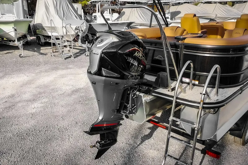 Slide: The Image of 2025 SunCatcher Fusion 324RC pontoon boat with Yamaha outboard motor in a marina. - 9