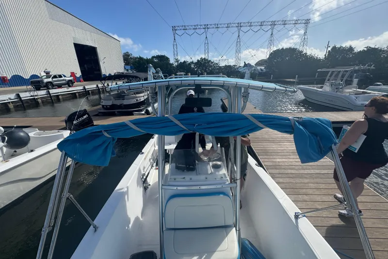 Slide: The Image of 2005 Angler 204 Center Console boat docked at marina with people nearby. - 21