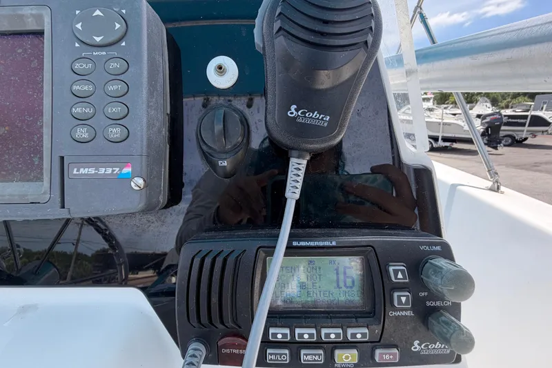 Slide: The Image of Control panel of a 2005 Angler 204CC boat with marine radio and GPS. - 27