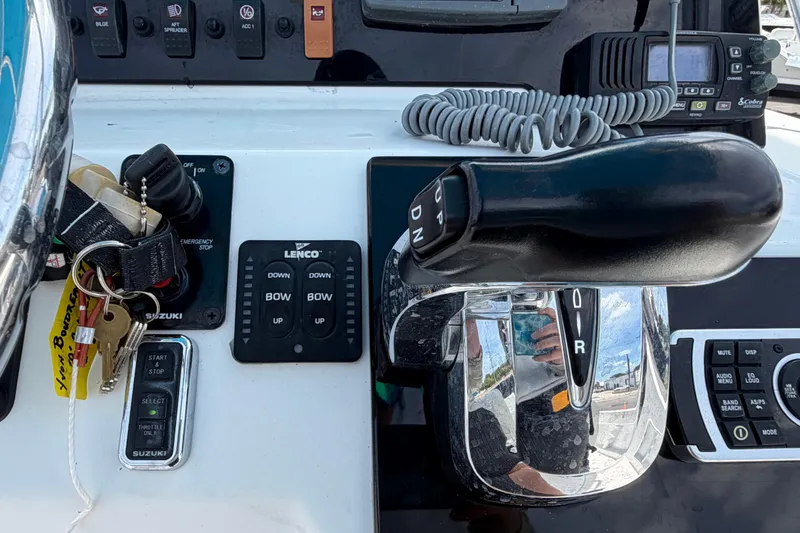 Slide: The Image of Control panel of a 2005 Angler 204CC boat with keys and throttle lever. - 28