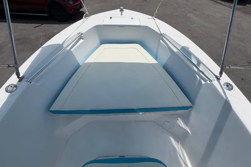 Slide: The Image of 2005 Angler 204CC boat interior with cushioned seating and stainless steel railings. - 32