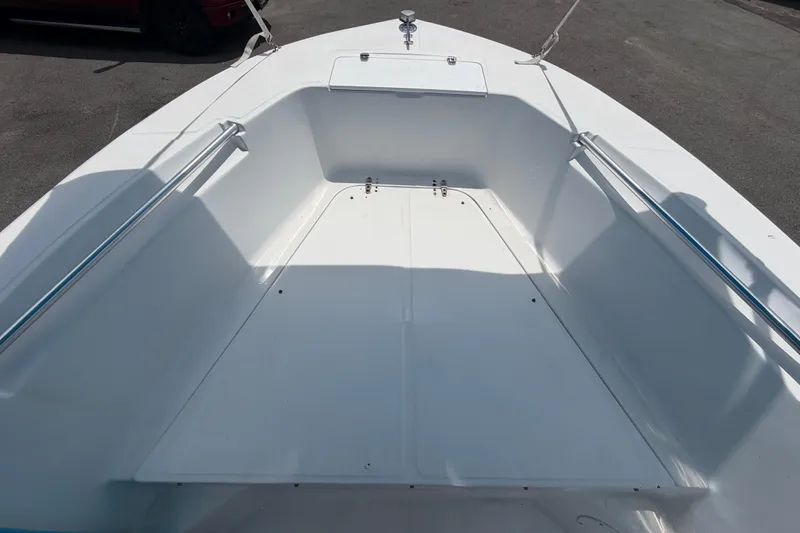 Slide: The Image of 2005 Angler 204CC boat interior, featuring spacious white deck and seating area. - 33