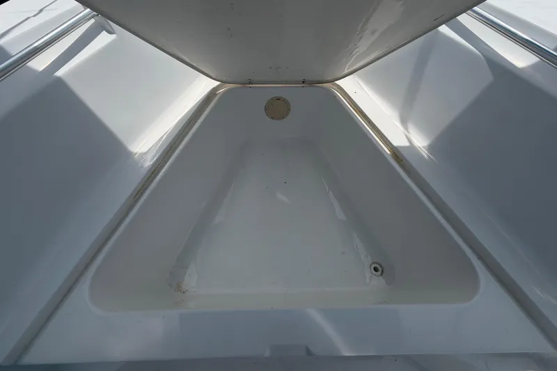 Slide: The Image of 2005 Angler 204CC boat storage compartment, featuring a clean, spacious interior. - 34