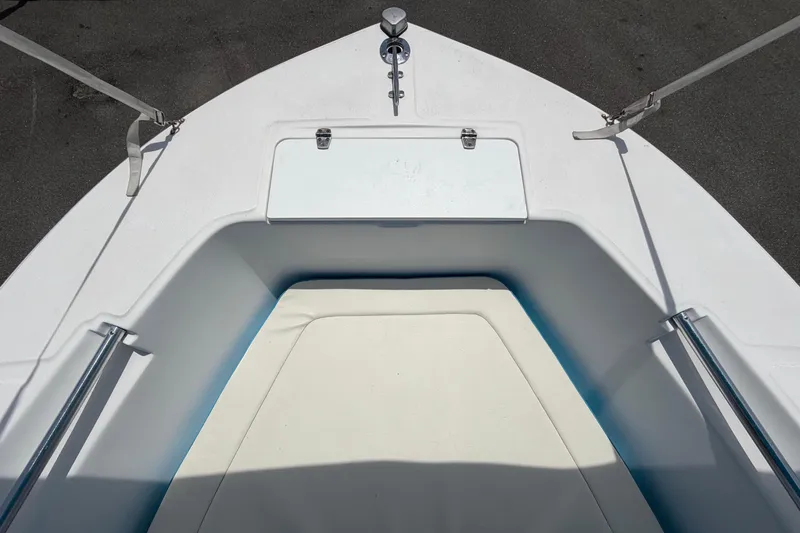 Slide: The Image of Bow view of a 2005 Angler 204CC boat, featuring a clean deck and storage hatch. - 35