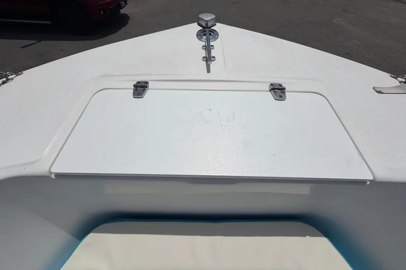 Slide: The Image of 2005 Angler 204CC boat deck with storage hatch and cleat. - 36