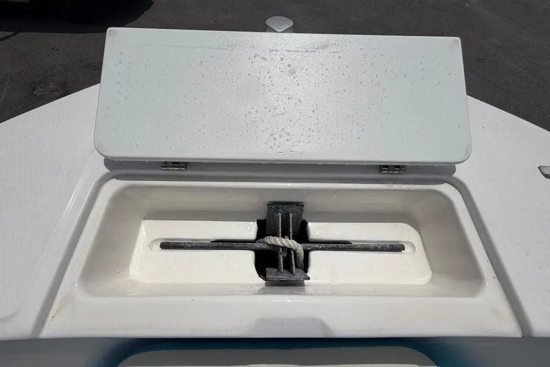 Slide: The Image of 2005 Angler 204CC boat anchor storage compartment with closed lid. - 37