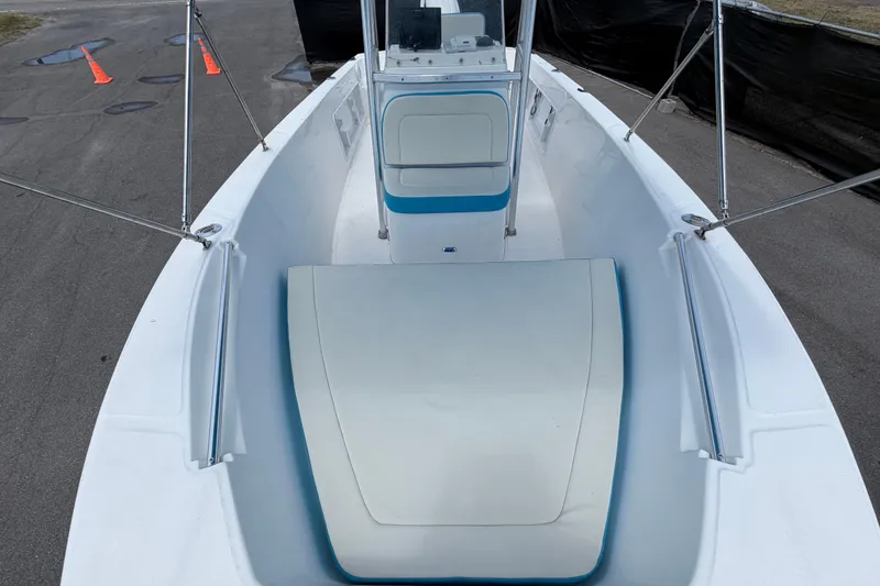 Slide: The Image of 2005 Angler 204CC boat interior with white seating and blue accents. - 38