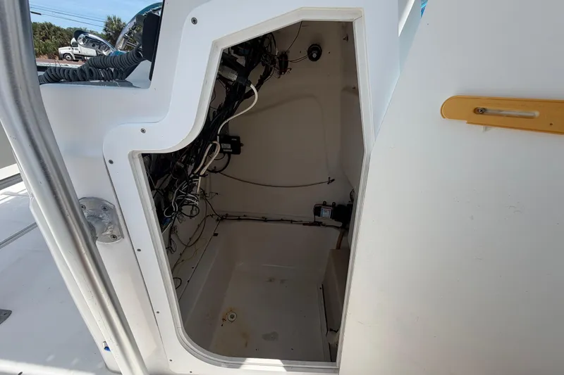 Slide: The Image of 2005 Angler 204CC boat interior wiring compartment with visible cables and equipment. - 45