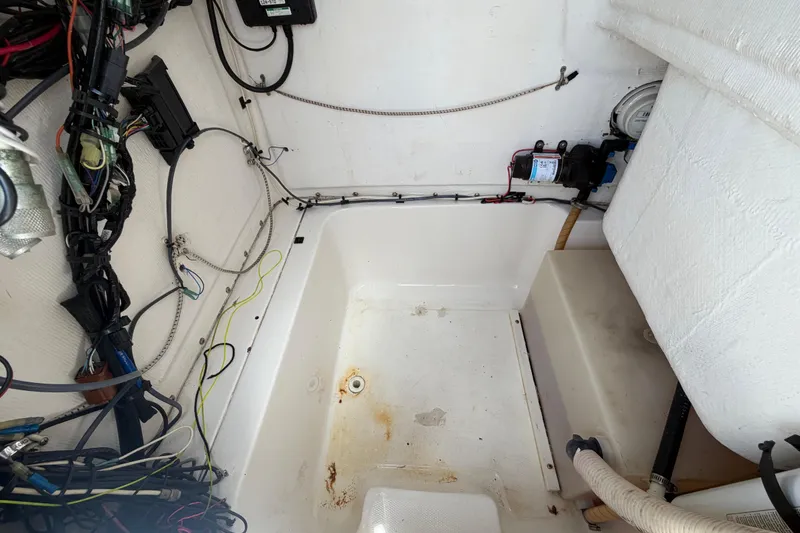 Slide: The Image of Interior view of a 2005 Angler 204CC boat showing wiring and equipment. - 46
