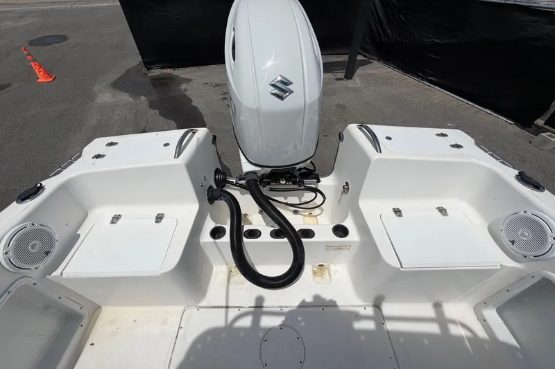 Slide: The Image of 2005 Angler 204CC boat interior with Suzuki outboard motor, featuring storage compartments and speakers. - 49