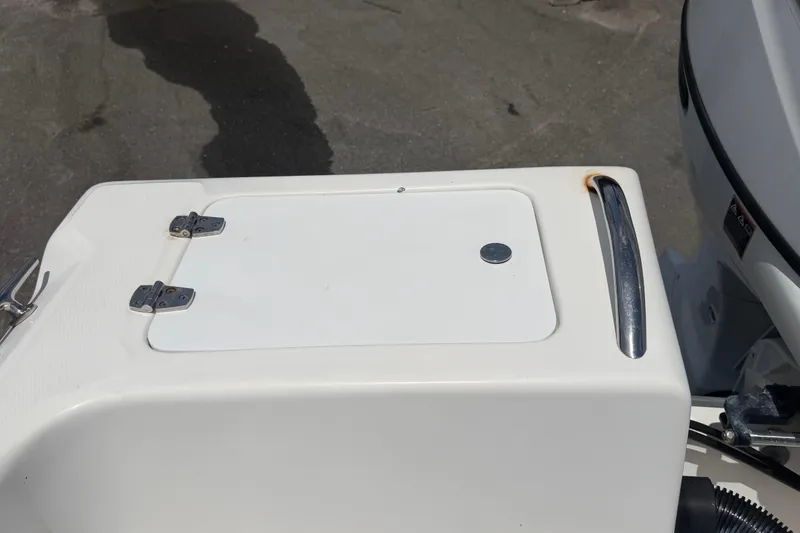 Slide: The Image of 2005 Angler 204CC boat hatch with metal handle and hinges. - 52