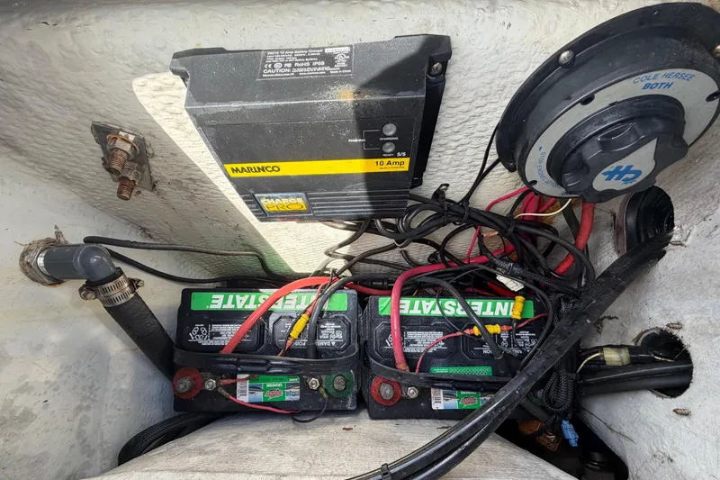 Slide: The Image of Electrical setup with batteries and wiring in a 2005 Angler 204CC boat. - 53