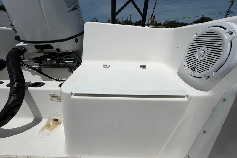 Slide: The Image of 2005 Angler 204CC boat interior with speaker and storage compartment. - 54