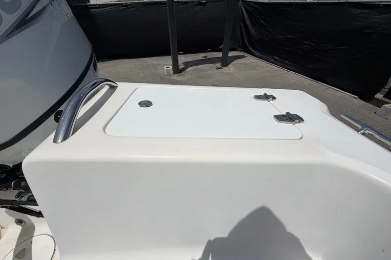 Slide: The Image of 2005 Angler 204CC boat detail, featuring a white hatch with metal handle and hinges. - 56