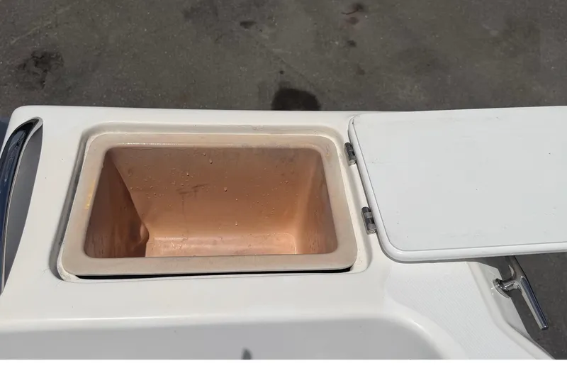 Slide: The Image of Open storage compartment on a 2005 Angler 204CC boat. - 57