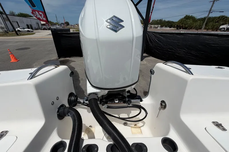 Slide: The Image of 2005 Angler 204CC boat with Suzuki outboard motor, displayed outdoors. - 59
