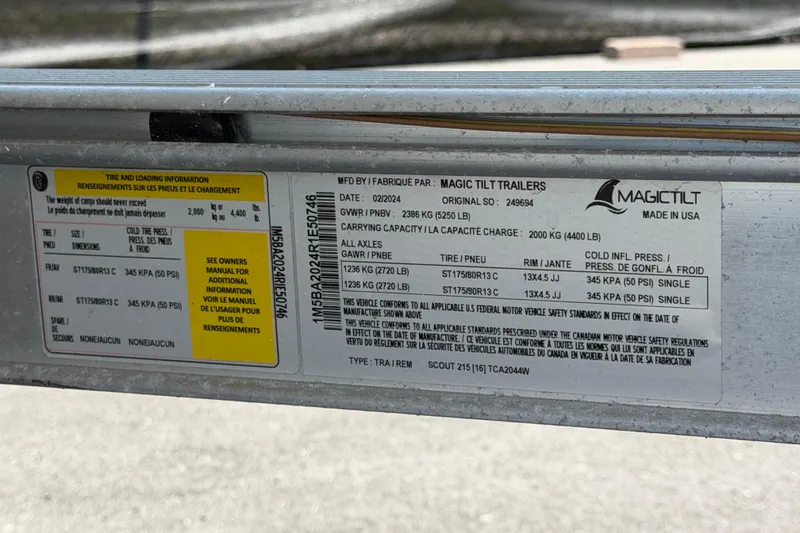 Slide: The Image of Label on Magic Tilt trailer showing tire and loading information, including weight limits and tire pressure. - 62