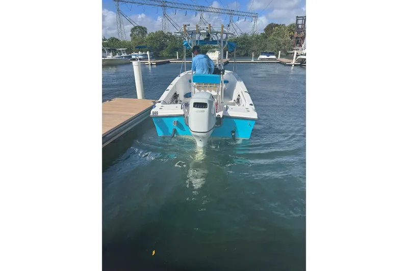 Slide: The Image of 2005 Angler 204 Center Console boat with Suzuki engine docked in marina. - 8