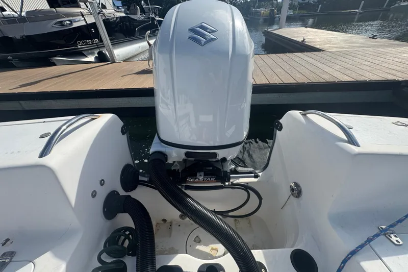 Slide: The Image of 2005 Angler 204 Center Console boat on lift against blue sky. - 9