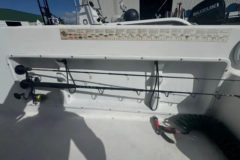 Slide: The Image of 2005 Angler 204 Center Console boat docked in a marina, rear view. - 13