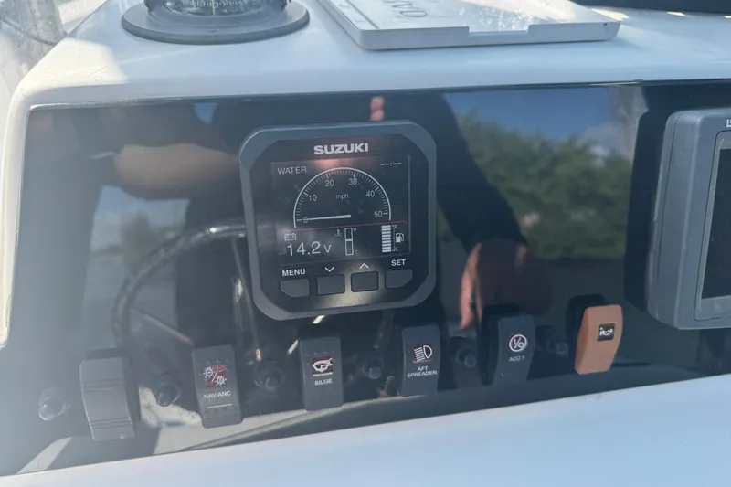 Slide: The Image of Fishing rods stored on a 2005 Angler 204 Center Console boat deck. - 18