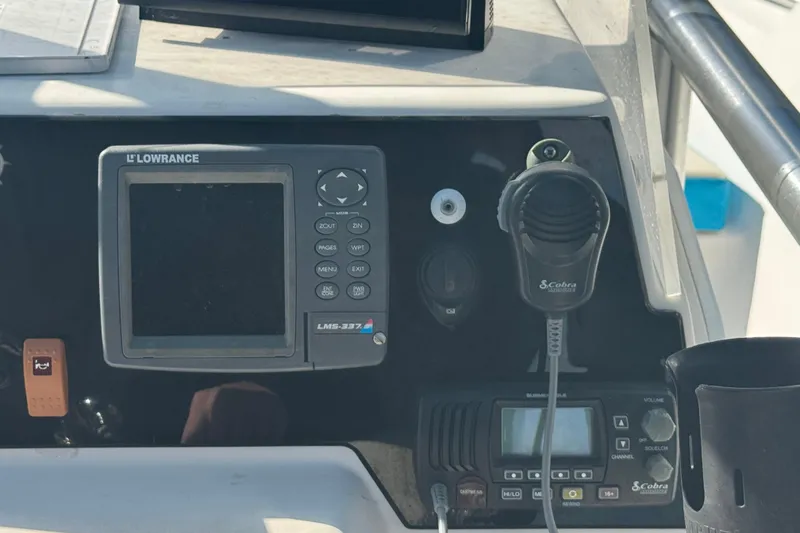 Slide: The Image of Control panel of 2005 Angler 204 Center Console with Lowrance and Cobra electronics. - 25